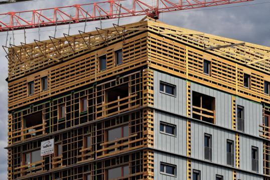  A building under construction using wooden panels, showcasing the craftsmanship and eco-friendly construction methods.