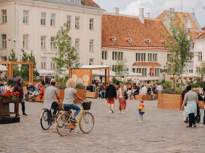 People walking around and biking in Tallinn's city centre