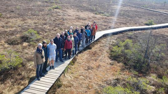 People walking together in a nature path without trees