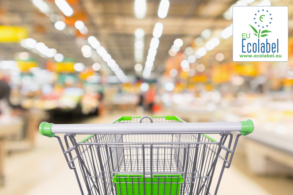 Shopping cart in a supermarket with EU Ecolabel logo, indicating eco-friendly products.