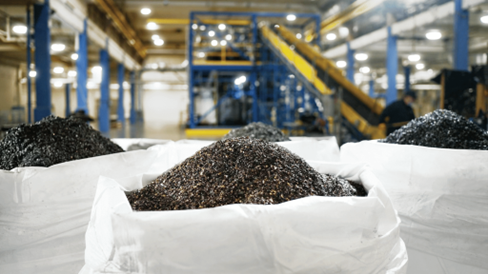 Battery waste known as 'black mass' fills up three bags in a battery recycling centre